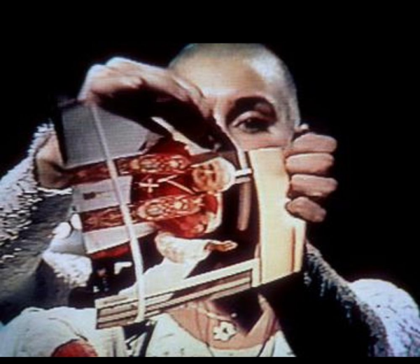 A close up image of Sinead O’Connor tearing up a picture of the Pope on Saturday Night Live