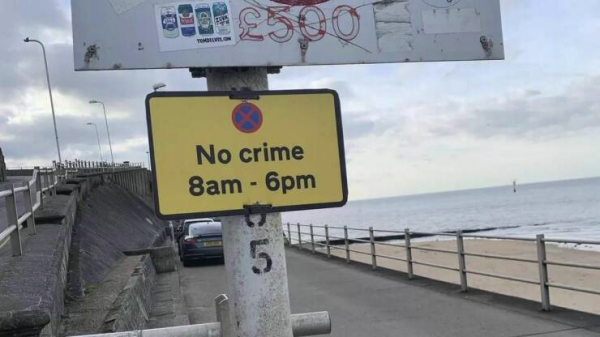 Sign at a beach that reads

No crime
8am - 6pm 