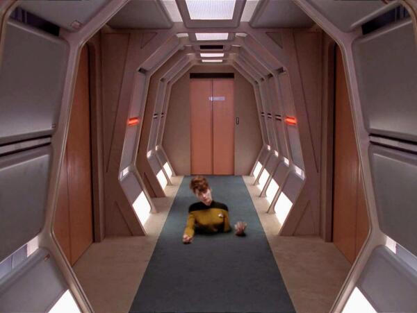 TNG scene. Pictured is the Enterprise D corridor, nicely carpeted of course, as one would expect of any space fairing vessel. A crewperson is shown from the stomach up, frozen in place in the floor. Like, as if the lower half of thier body is dangling from the ceiling on the next deck down. No caption. PRETTY SPOOKY 🎃