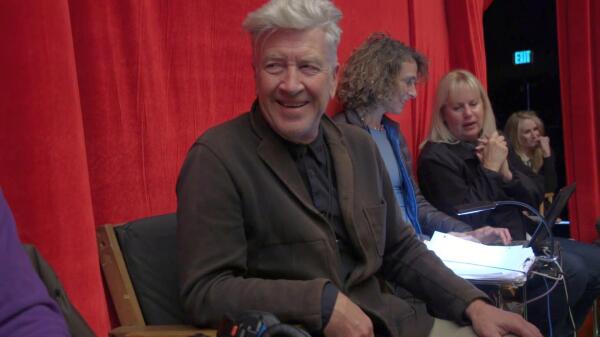 David Lynch laughing sitting in the director's chair on set of Twin Peaks: The Return.