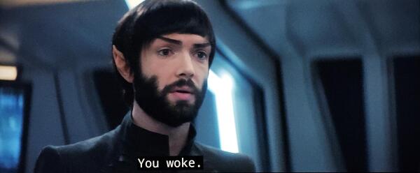 Star Trek Discovery scene. We're in the medical unit and close in on Spock. He's younger here and has a thick beard so you know he's probably going through some stuff. Closed caption reads, "You woke."