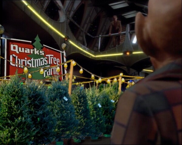 Quarks Christmas Tree farm sign and high quality authentic earth pine trees for sale on the promenade. Odo looks on in the background.
High quality Quarks merchandise available now, come quick. Bring your latinum 