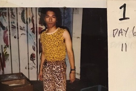 A polaroid photo of actor Renoly Santiago in an animal print themed outfit.