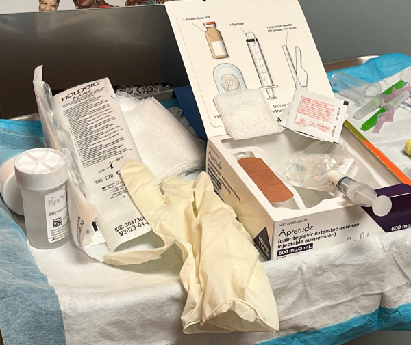 Closeup of a medical tray with gloves, syringe, and medical equipment to delivery a PrEP injection.